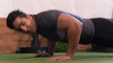 muscular-man-performing-a-variation-of-the-classic-push-up-exercise