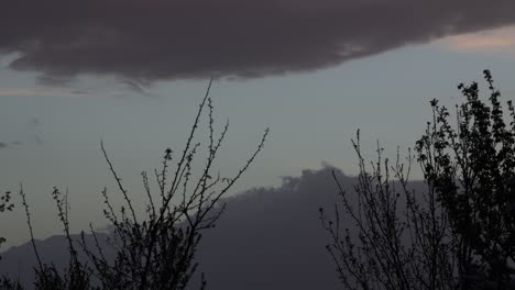 Big-Clouds-Forming-Over-The-Landscape-During-Sunset---timelapse