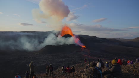 People-Watching-And-Taking-Videos-Of-Volcanic-Eruption-With-Hot-Lava-Exploding-From-The-Crater-In-Geldingadalir,-Iceland
