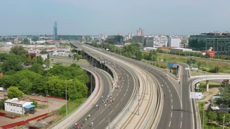 People-running-on-Ada-Bridge-for-Belgrade-marathon-event,-aerial-view
