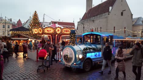 Estonia,-Tallinn-Raekoja-Plats-,-Christmas-market,-kids-are-playing-on-the-carousel
