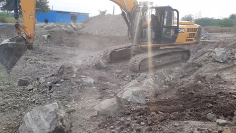 Excavator-removing-rock-and-soil-from-the-construction-site