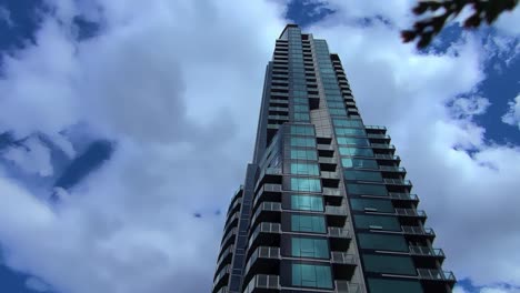 Worms-Eye-View-Upwards-of-the-Pearl-luxury-condominium-located-in-Oliver-district-in-the-rivers-edge-above-the-valley-area-of-downtown-Edmonton-on-a-sunny-mirrored-reflection-of-clouds-on-the-building
