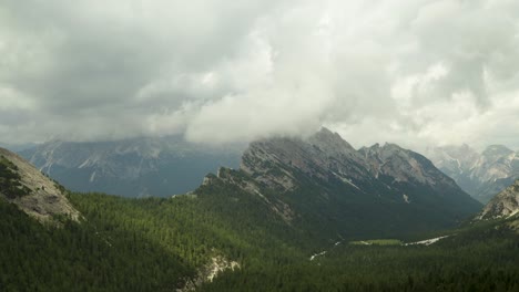 Rain-clouds-moving-over-beautiful-mountain-range-in-Dolomites,-ITaly