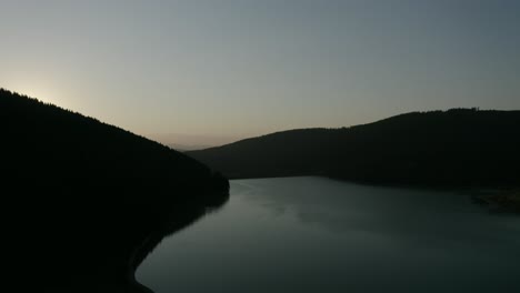 Calm-Waterscape-Of-Frumoasa-Dam-During-Golden-Sunset-In-Frumoasa,-Harghita-County,-Romania