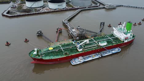 Silver-Rotterdam-chemical-oil-tanker-ship-loading-at-Tranmere-terminal-Liverpool-aerial-view-high-orbit-right