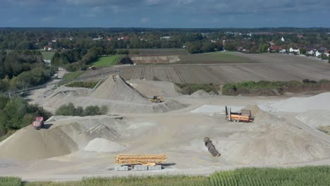 An-excavator-at-work-at-a-hugh-sand-pit-in-aerial-view