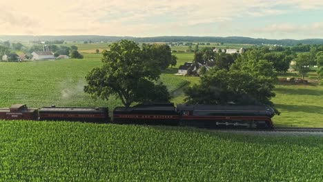 Aerial-Landscape-of-Farmlands-and-a-Antique-Steam-Engine-Passes-Thru-the-Corn-Fields-on-an-Early-Summer-Morning