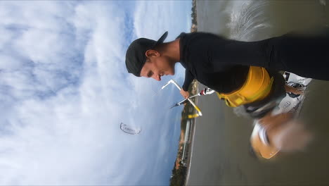 Caucasian-man-holding-GoPro-while-kite-surfing-on-ocean