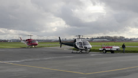 Police-And-Search-And-Rescue-Helicopters-At-The-Heliport-Ready-For-Takeoff-In-British-Columbia,-Canada