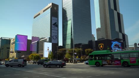 World-Trade-Center-Seoul---Cars-Traffic-Turning-at-Crossroads-Passing-Samseong-Station-near-Coex-Trade-Tower-and-Parnas-Tower-And-Grand-Intercontinental-Hotel-at-Sunset-in-Autumn,-Korea