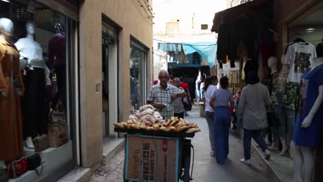 Walking-On-A-Busy-Street-At-The-Marketplace-In-Tunis,-Tunisia