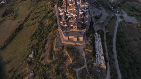 Aerial-top-down-forward-over-Monsaraz-village-on-hill-at-sunset,-Portugal
