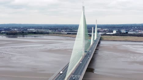 Mersey-gateway-landmark-aerial-view-above-toll-suspension-bridge-river-crossing-slow-jib-down-shot