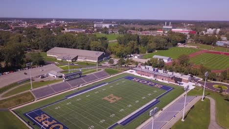 Aerial-parallax-of-sport-fields-at-Hope-College-in-Michigan,-sunlight