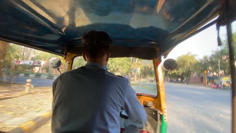 Wide-motion-time-lapse-view-of-tuk-tuk-ride-around-Delhi,-India,-Indian-culture,-travel-and-transportation-concept