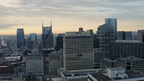Aerial-drone-view-of-downtown-Nashville-Tennessee-skyline-at-sunset,-4K