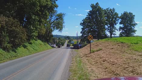 An-Amish-Horse-and-Buggy-Trotting-Down-a-Country-Road-Passing-Cars,-on-a-Beautiful-Sunny-Day
