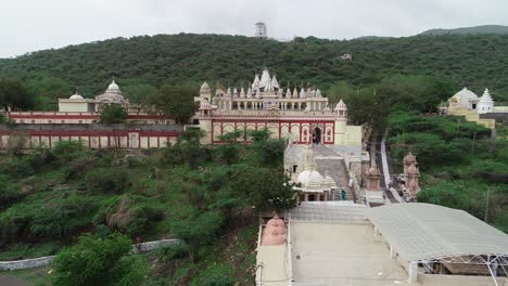 Aerial-forward-drone-shot-of-the-Palitana-temple-surrounded-with-temple-and-trees