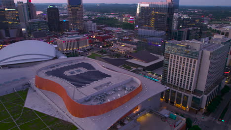 Aerial-view-around-Music-city-center,-revealing-the-skyline-of-gloomy-Nashville,-USA---circling,-drone-shot