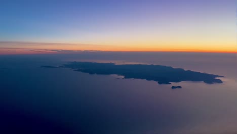 Aerial-view-of-Ibiza-Island,-in-Spain,-during-sunset,-pilot-point-of-view,-from-a-jet-cockpit-4K-60FPS