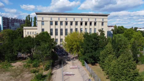 Perfect-aerial-view-flight-fly-backwards-drone-footage-of-the-toughest-Club-door-Bouncer-in-the-World-Berghain-Berlin-Friedrichshain-Summer-2022