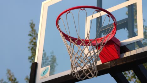 person-shooting-a-basketball-on-a-new-hoop-and-missing-the-first-time,-then-making-a-shot-off-the-backboard