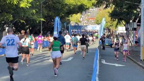 Participants-running-towards-the-finish-line-with-joys-and-sweats,-Bridge-to-Brisbane-fundraise-event-to-raise-funds-for-charity,-people-show-love-and-support-for-good-cause,-handheld-motion-shot