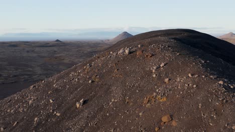 Dormant-volcano-cones-in-wild-rugged-Iceland-landscape,-aerial