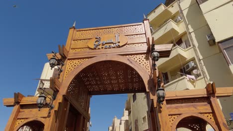 Wooden-entrance-to-the-market-of-El-Souk-on-a-clear-day-in-the-city-of-Luxor-in-Egypt