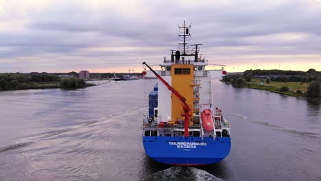 Tracking-Shot-From-Rear-Side-Of-Tailwind-Panda-Container-Ship-Cruising-Oude-Maas-River,-Netherlands