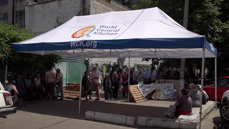 People-wait-in-the-shade-for-food-aid-to-arrive-under-a-World-Central-Kitchen-tent-at-a-Mykolaiv-distribution-centre-during-the-Russian-war-in-Ukraine