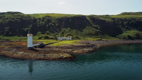 Aerial-drone-shot-of-the-Tobermory-Lighthouse-and-rocky-Isle-of-Mull-coastline