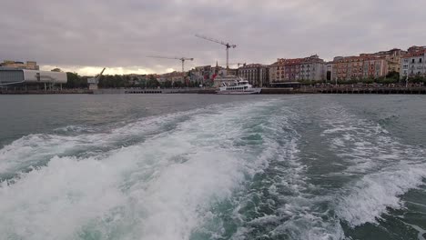 Leaving-Santander-port-bay-view-from-a-ferry-boat-during-sunset-cloudy-summer-day
