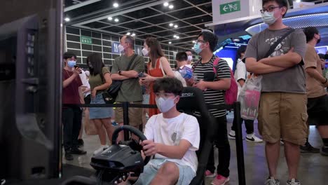 A-visitor-plays-a-themed-racing-videogame-during-the-Anicom-and-Games-ACGHK-exhibition-event-in-Hong-Kong