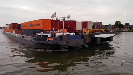 Aerial-Close-Up-View-Off-Forward-Bow-Of-Maas-Inland-Push-Tow-Cargo-Barge-Along-River-Noord