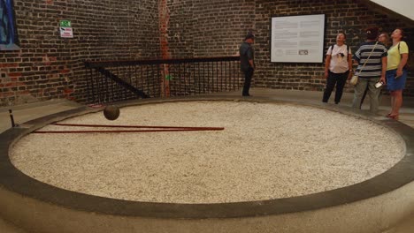Tourist-At-Foucault's-Pendulum-Inside-The-Ancient-Planetarium-Bell-Tower-On-Cathedral-Hill,-Frombork