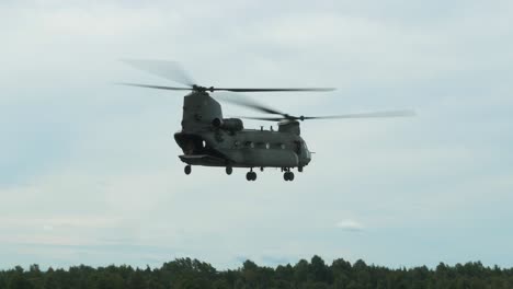 Chinook-CH47-helicopter-flying-slowly-sideways-with-slow-rotation-at-air-show