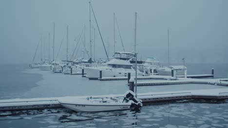 An-early-winter-morning-on-the-Poulsbo-Harbor-during-a-rare-Seattle-snow-storm,-looking-out-at-the-boats