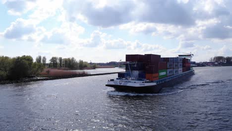 Container-Ship-Navigates-The-Oude-Maas-River-In-Puttershoek