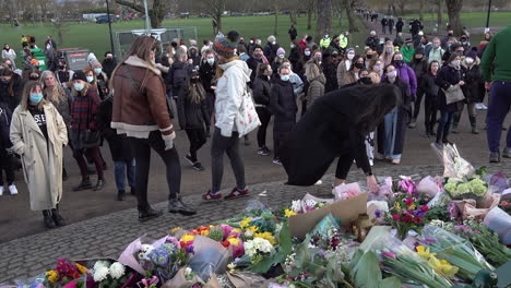 People-come-forward-and-lay-flowers-at-a-memorial-at-the-Clapham-Common-bandstand-during-a-vigil-for-Sarah-Everard,-who-was-kidnapped-and-murdered