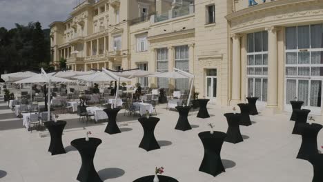 Cocktail-Tables-Covered-With-Black-Cloth-Arrangement-At-Hotel-Balcony-For-The-Night-Party