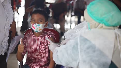 Yogyakarta,-Indonesia---Dec-20,-2021-:-an-elementary-school-boy-is-receiving-the-covid-19-vaccine