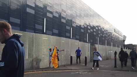 Slow-motion-of-a-father-and-son-taking-a-selfie-with-the-Lion-Rampant-flag-outside-Hampden-Park