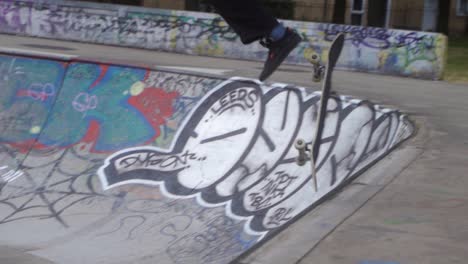 Slow-mo-of-skate-boarder-at-a-skate-park-in-Sheffield,-England-jumping-up-ramp