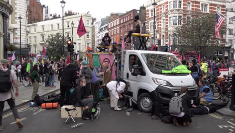 Extinction-Rebellion-climate-chance-protesters-use-a-van-to-block-a-Covent-Garden-junction-by-using-lock-on-direct-action-tactics-underneath-the-vehicle