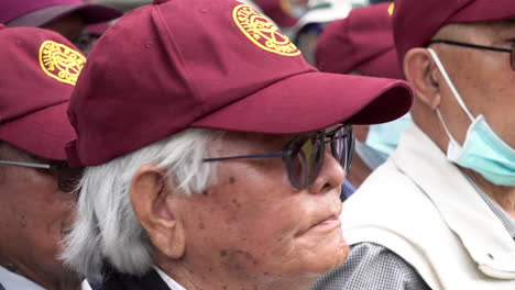 An-elderly-British-Ghurka-veteran-stands-together-with-others-wearing-a-maroon-baseball-cap-during-a-protest-opposite-Downing-Street,-to-call-for-full-military-pensions-for-all-Ghurka-veterans
