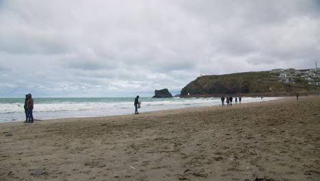 Coastal-Scenic-Shot-of-Portreath-Beach-with-People-and-Families-Walking-Along-the-Sandy-Shores-of-Cornwall