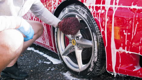 Sports-car-being-professionally-clean-by-hand
