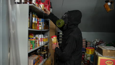 A-prepper-in-a-gas-mask-preparing-for-doomsday-by-stockpiling-food-in-a-nuclear-bomb-shelter-bunker